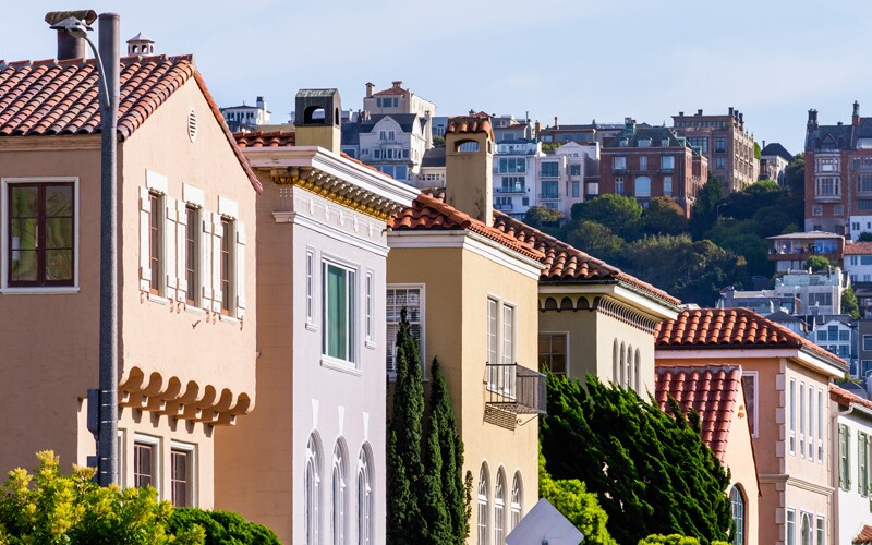 Row of colorful houses in the Marina District residential neighborhood; Pacific Heights residential district visible in the background