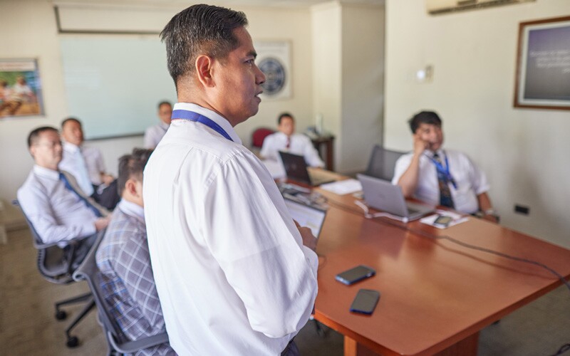 A group of men in an office space, having a team meeting.