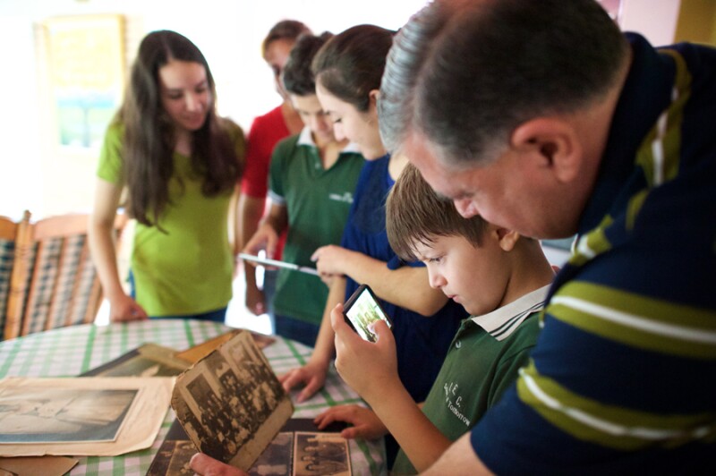 Boy digitizing family history photos.