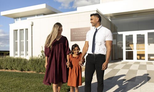 A family at a church building for The Church of Jesus Christ of Latter-day Saints in New Zealand.