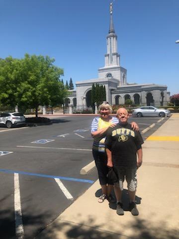 Dennis and his sister standing in front of a temple built by the Church of Jesus Christ of Latter-day Saints.