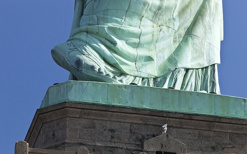 The statue of liberty's foot symbolizes progress toward freedom.