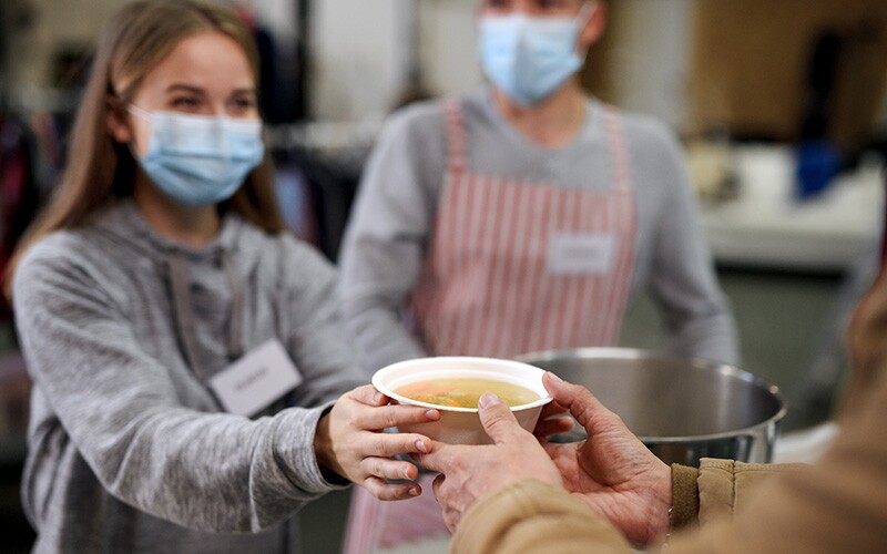 A girl volunteers at her local soup kitchen for Boxing Day.