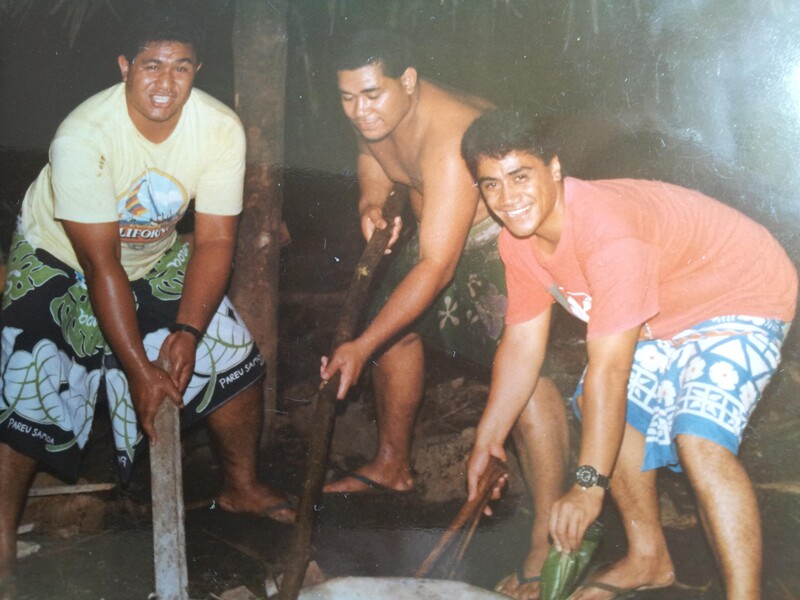 Three friends participate in Samoan coconut husking, a Samoan tradition