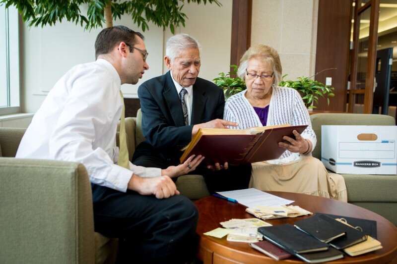 Couple sharing photos with archivist.