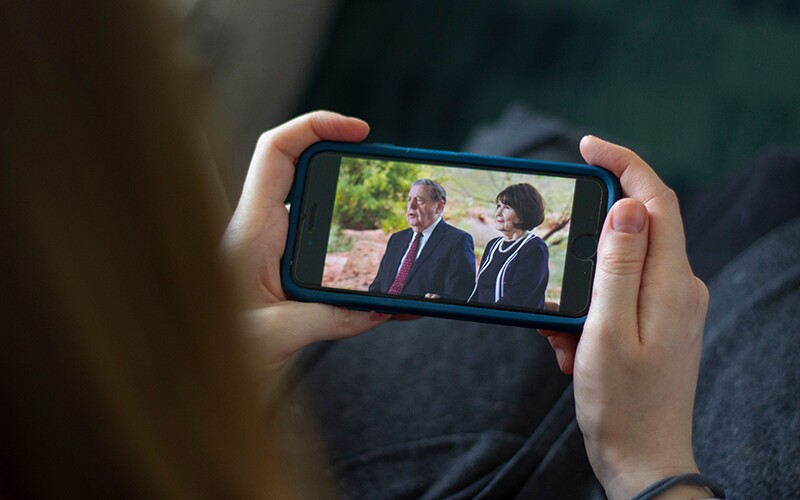 a person watches rootstech on their phone.