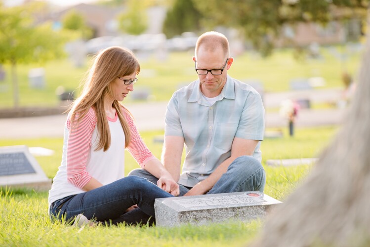 A couple visits a gravesite