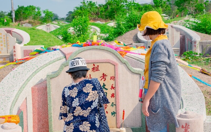 Families celebrate the Qingming Festival, also known as Tomb-Sweeping Day, by visiting ancestral graves