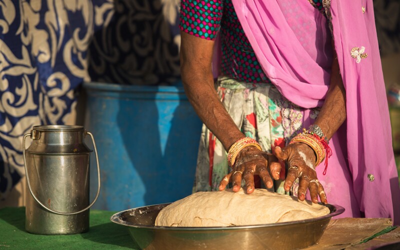 a woman makes a type of world cuisine bread.