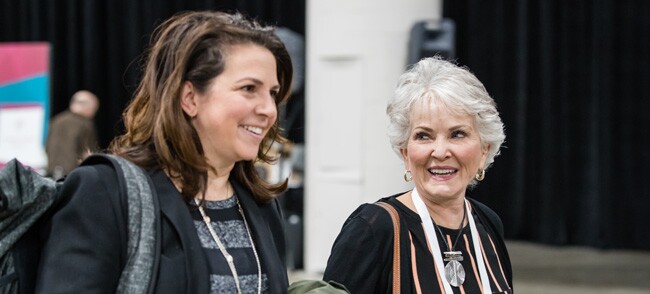 Two ladies attending RootsTech, where the Light Keepers event takes place.