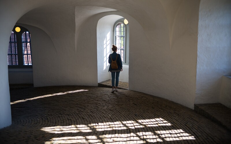 The Round Tower interior with girl looking out window