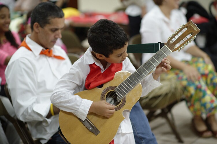 a young boy plays a guitar