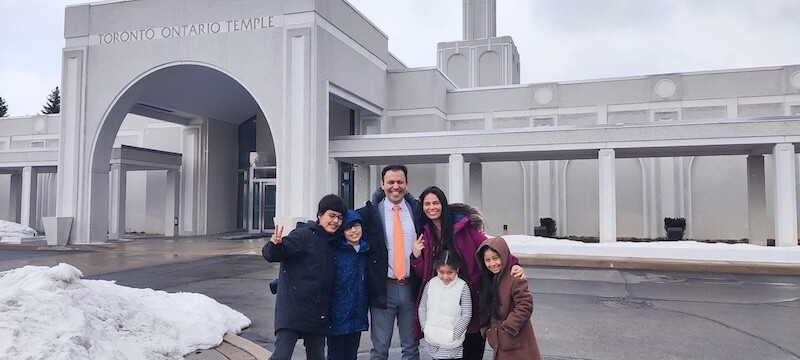 Basilio, Angelica, and their children smile in front of the Toronto Ontario Temple.