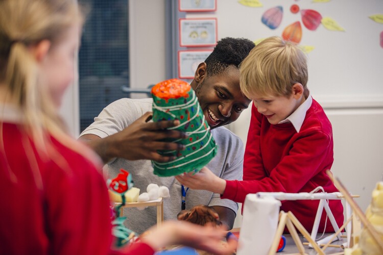 A father helps his son with a science experiment.