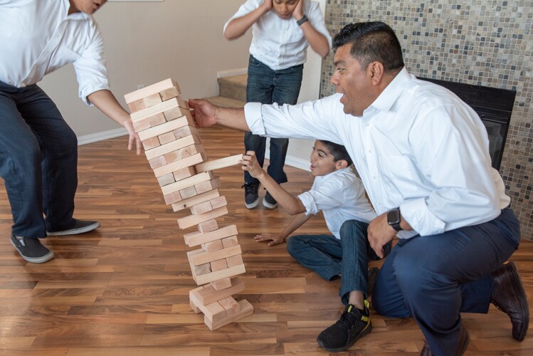 A family plays a game together on Father's day.