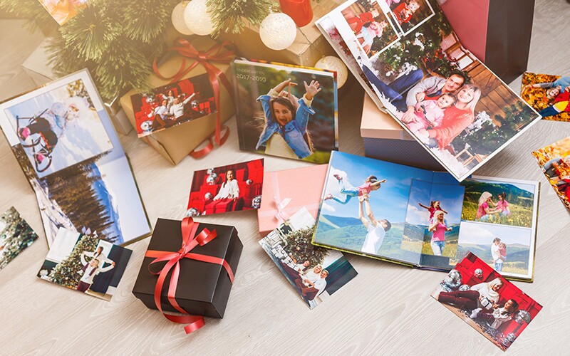 Photo albums and other genealogy gifts under a Christmas tree
