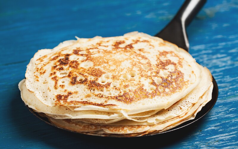 english pancakes on a cast-iron skillet.
