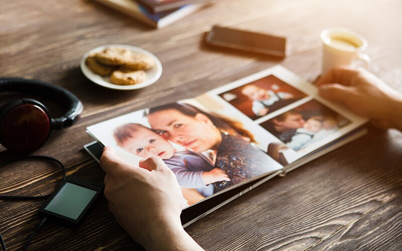 Woman looks through pictures in a chatbook she created.