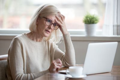 a middle-aged woman is stuck on a problem while doing genealogical research